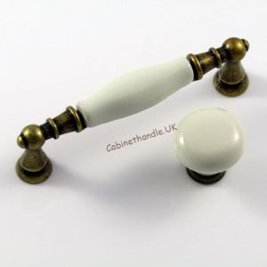 set of two porcelain cabinet pulls made of smooth ivory porcelain and metal finish in old brass colour