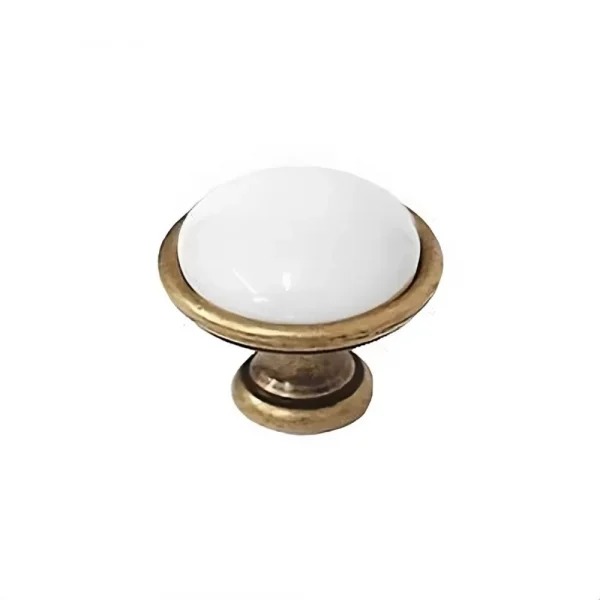 white ceramic and antique brass knob